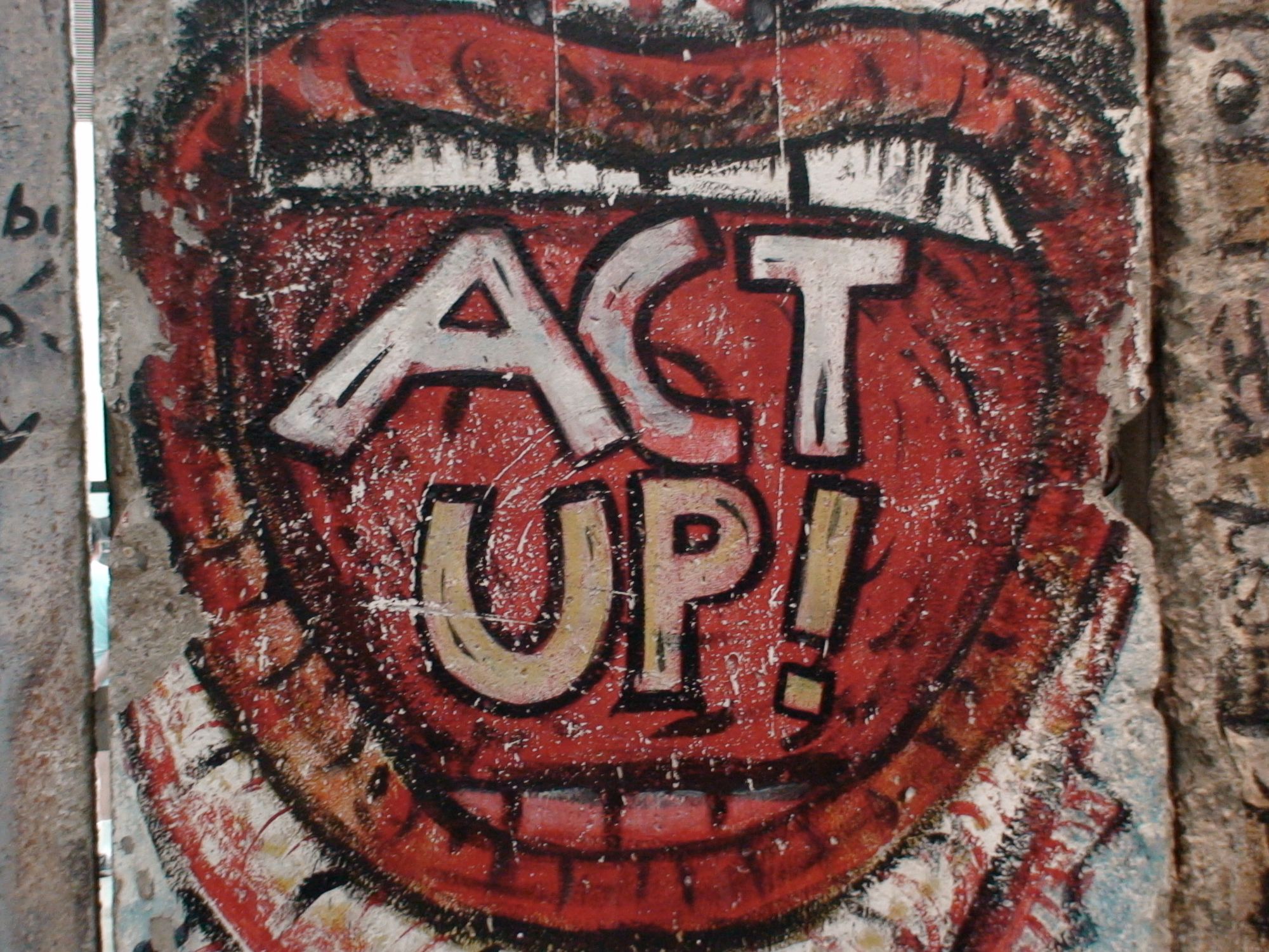 An image of graffiti depicting an open mouth with text inside saying "ACT UP".